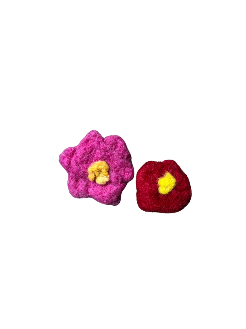 Needle-felted flowers in pink and red with yellow centres